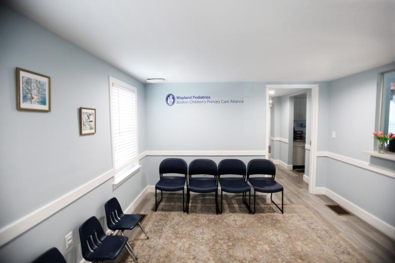an empty waiting room with wayland pediatrics on the wall